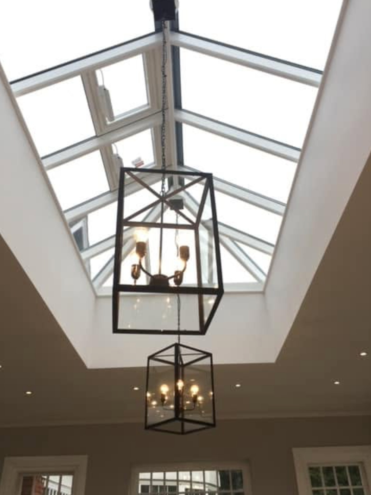 Screenshot 2026-10-07 at 16.27.48 Geometric pendant light suspended beneath a glass roof lantern