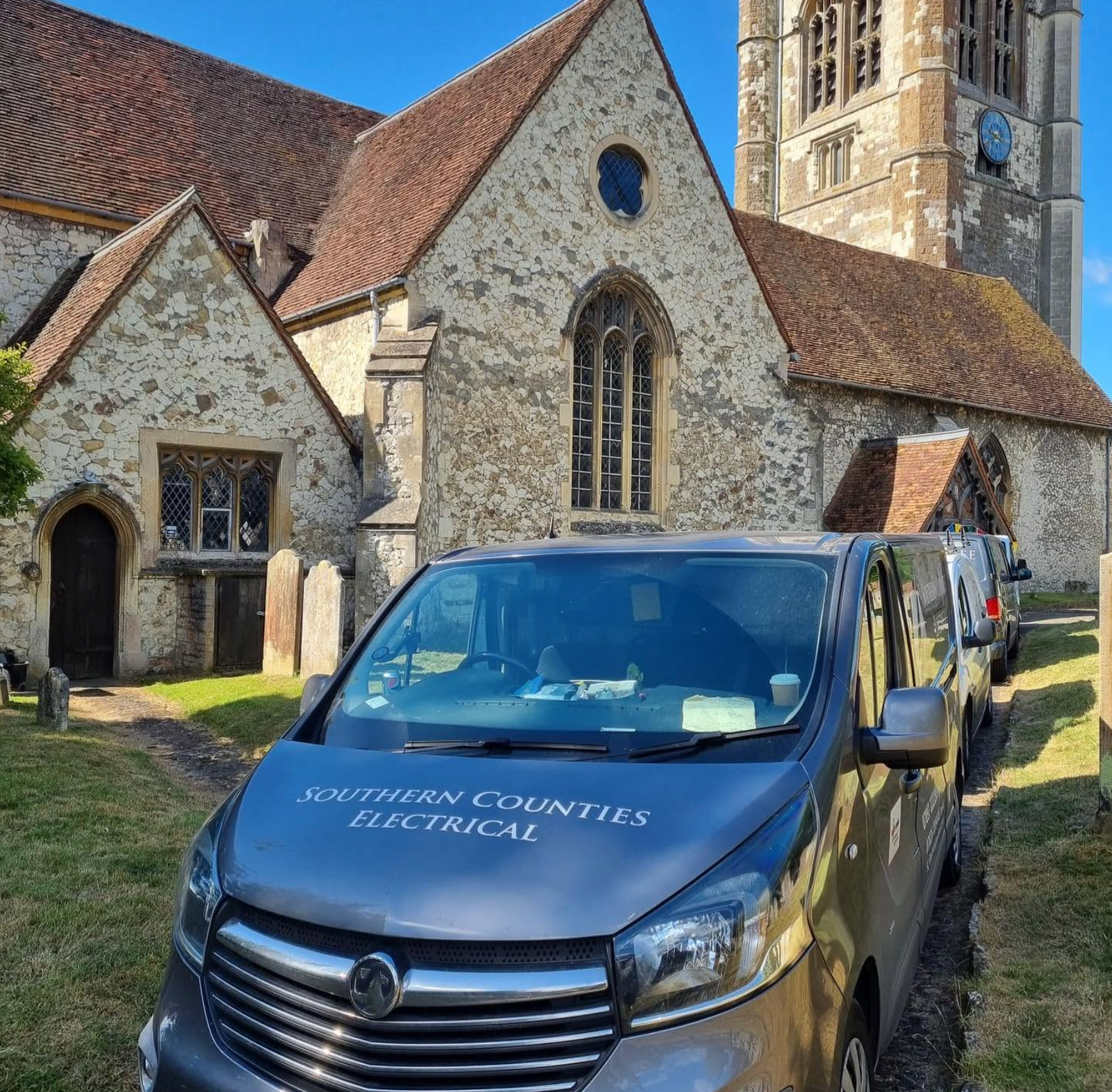 Screenshot 2026-10-07 at 16.27.59 Electrical contractor’s van parked outside a stone church