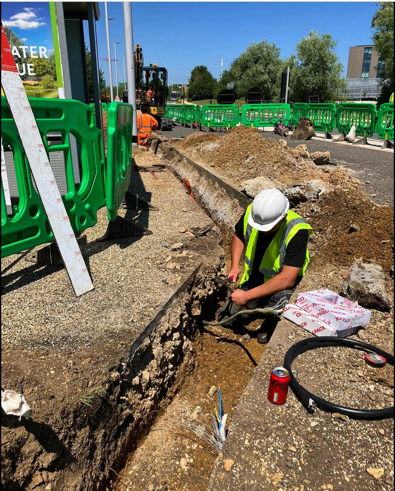 Screenshot 2026-10-07 at 16.28.24 Electrical contractor working beside an excavated cable trench
